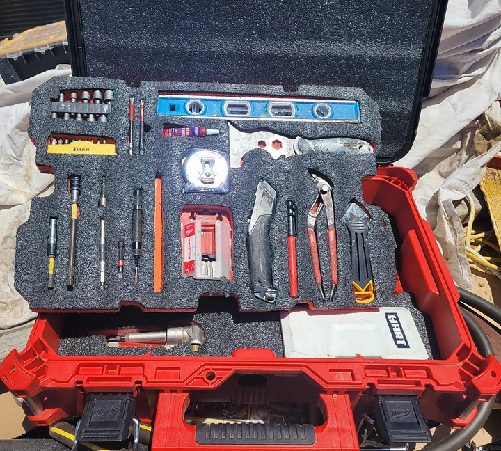 Evan's open tool case, with hand tools and accessories organized in fitted foam.