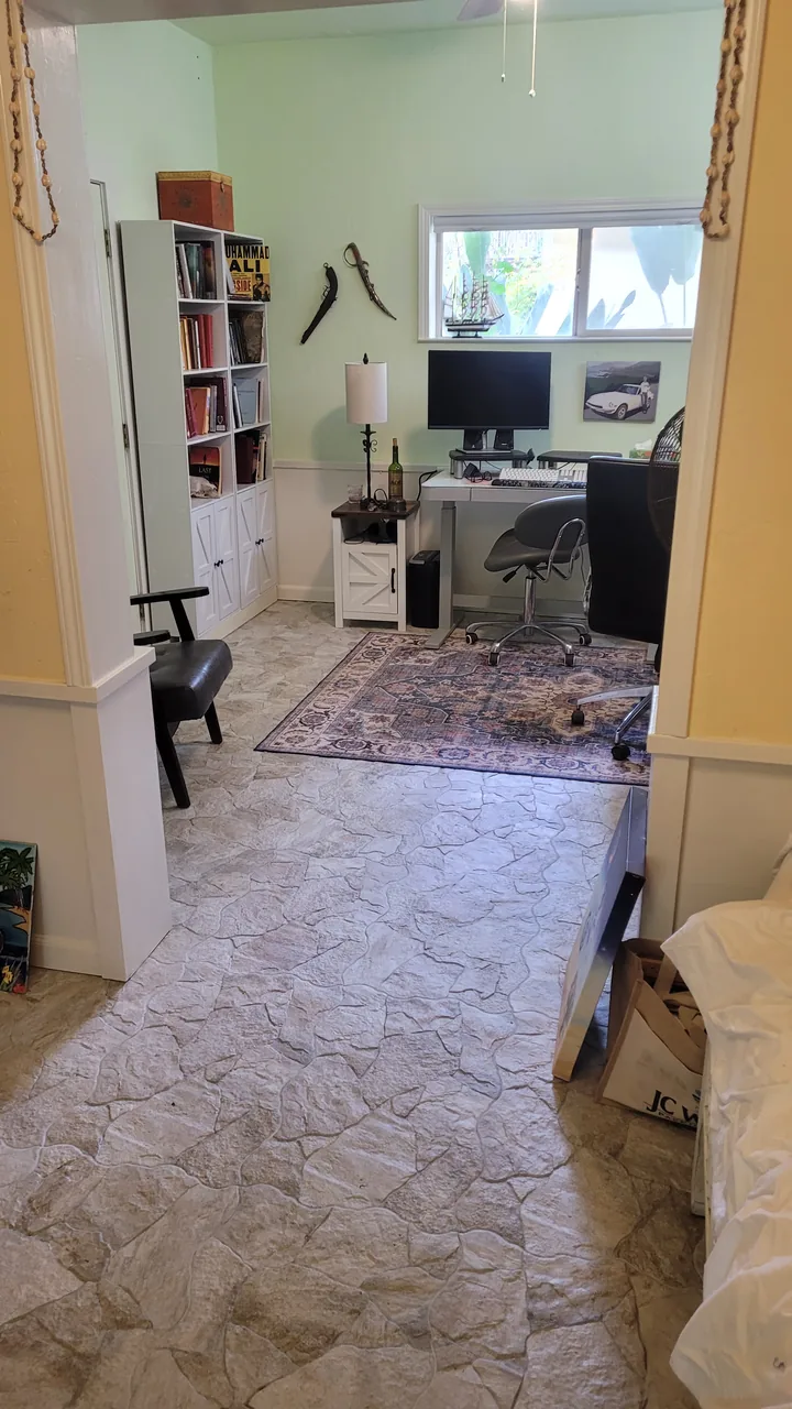 Finished office with natural stone flooring and painted walls and trim.