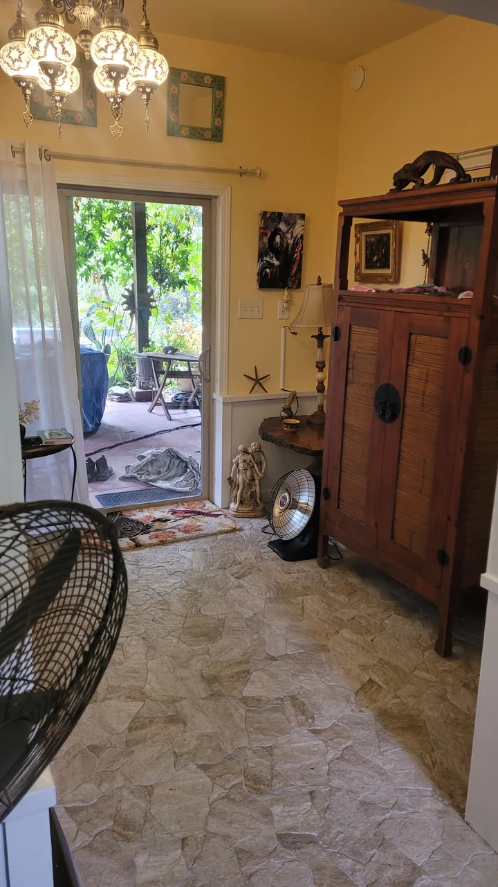 Another finished interior view showing the natural stone floor, painted walls and trim, and the owner's furnishings.