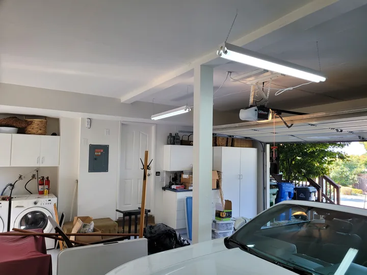 Finished garage with enclosed ceiling ductwork and painted walls and ceiling.